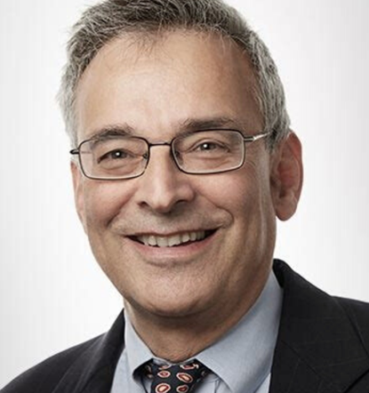 A view of a church sanctuary with wooden pews, large windows, and a warm inviting atmosphere.